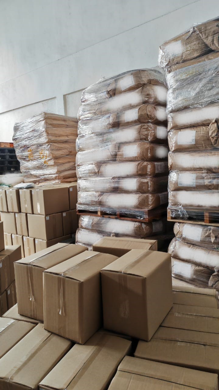 Pallets of sacked raw material stacked beside cartons in the Beyond Lohas store